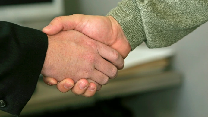 Handshake between founder and client